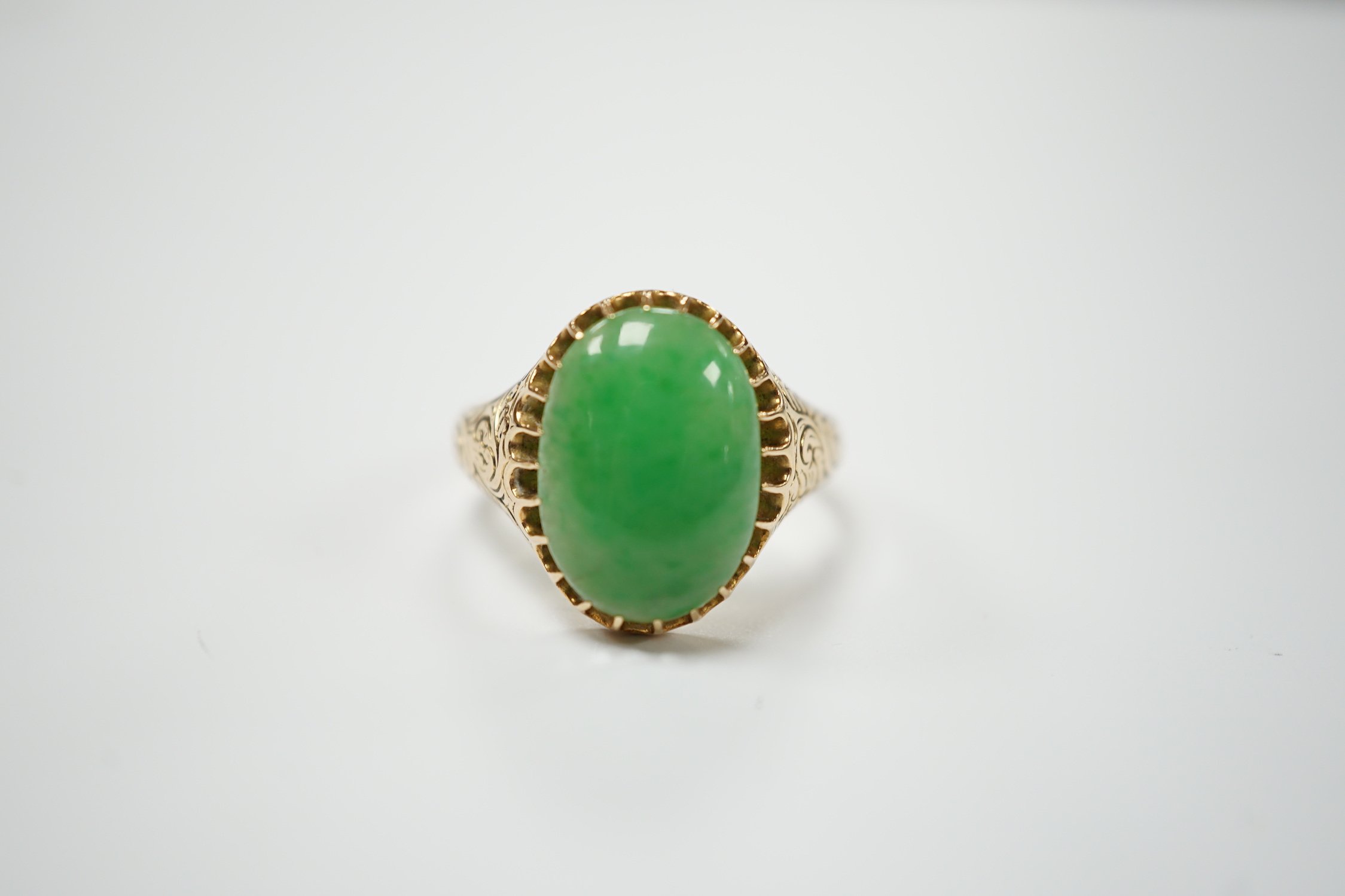 A yellow metal (stamped 18) and single stone cabochon jade set ring, size Q, gross weight 5.7 grams.